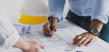 Image of building plans and a hardhat